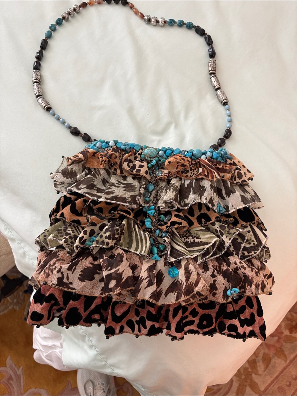 Mary Frances Ruffled Animal Print Crossbody with Turquoise Bead Accents